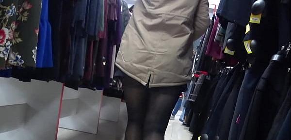  Voyeur peeks under her skirt in public. And with a hidden camera in a fitting room spies on a girl with a juicy ass in nylon tights. Foot fetish.
